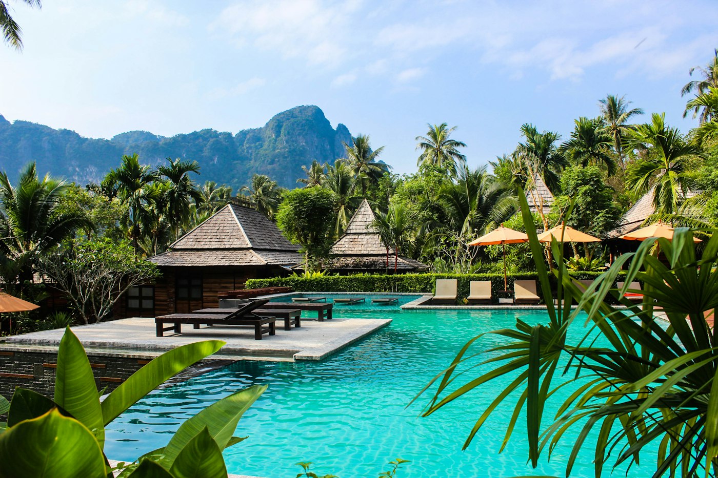 Lounge chairs at a sunlit resort pool